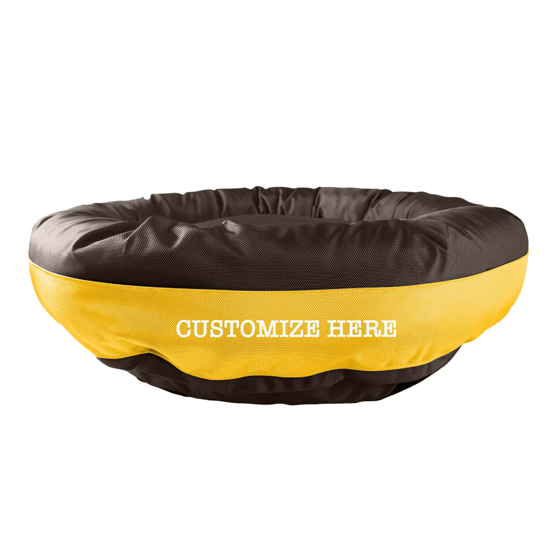 Brown round bolstered dog bed with a yellow band and white embroidered 'Customize Here'.
