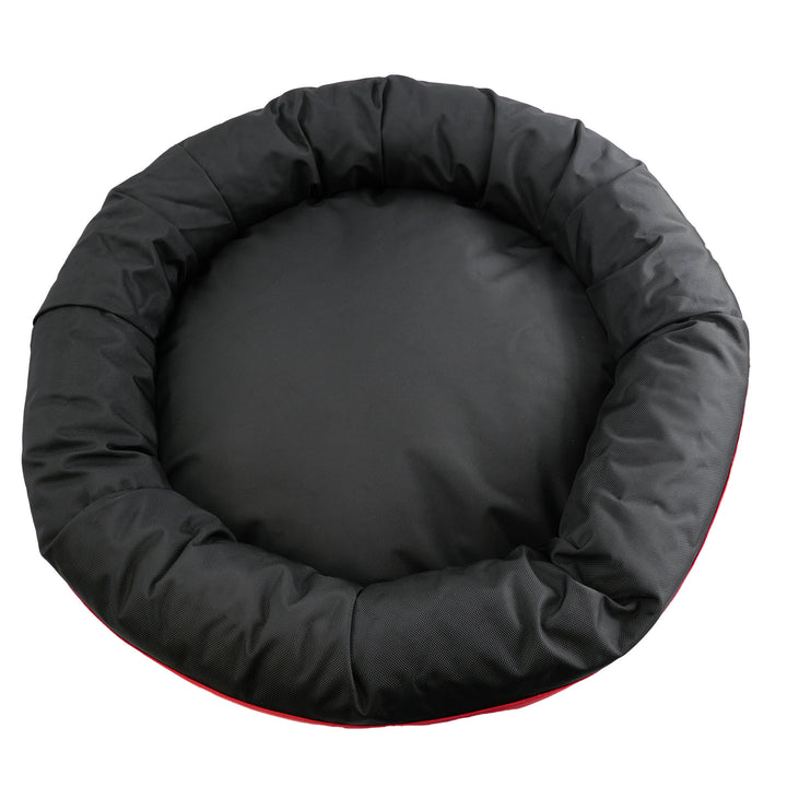 Top view of a black round bolstered dog bed.