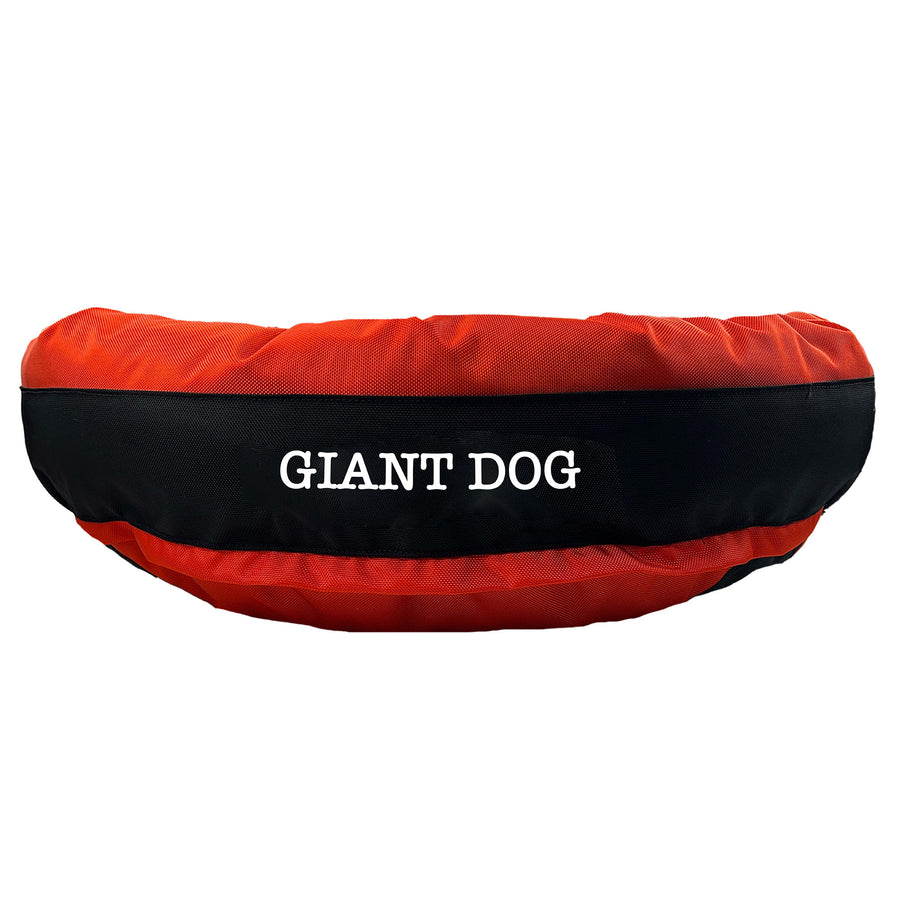 Orange round bolstered dog bed with black band and white embroidered 'Giant Dog'.
