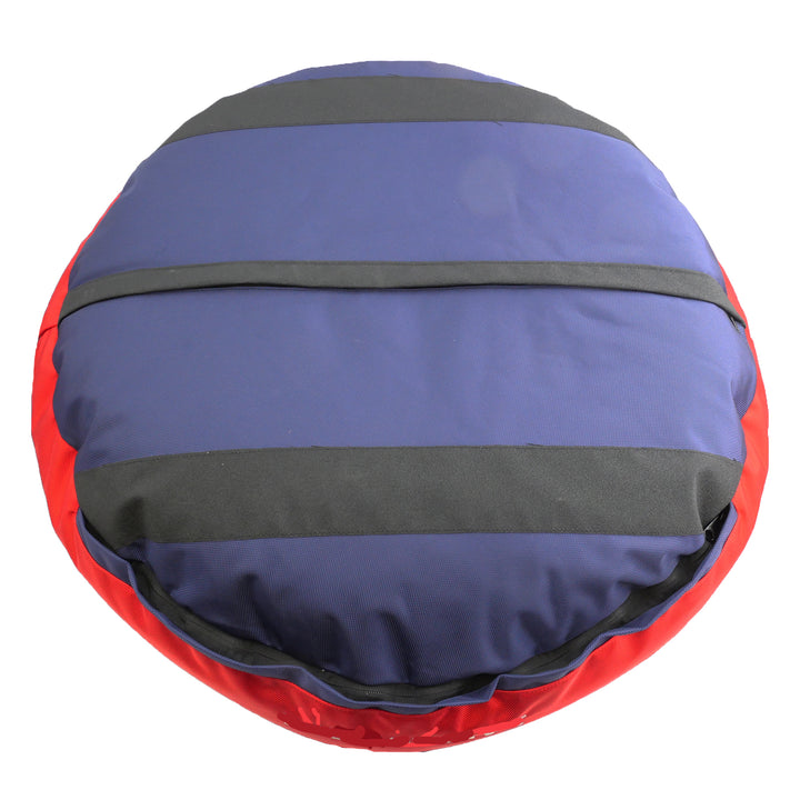 Bottom of navy round bolstered dog bed with black strips and red band.