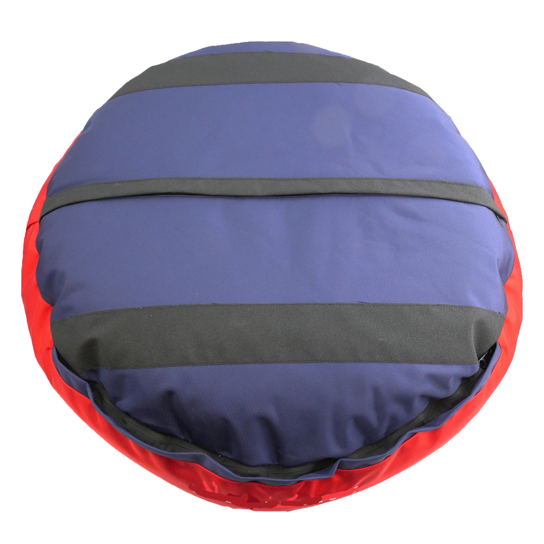 Bottom of blue round bolstered dog bed with black strips and red band.