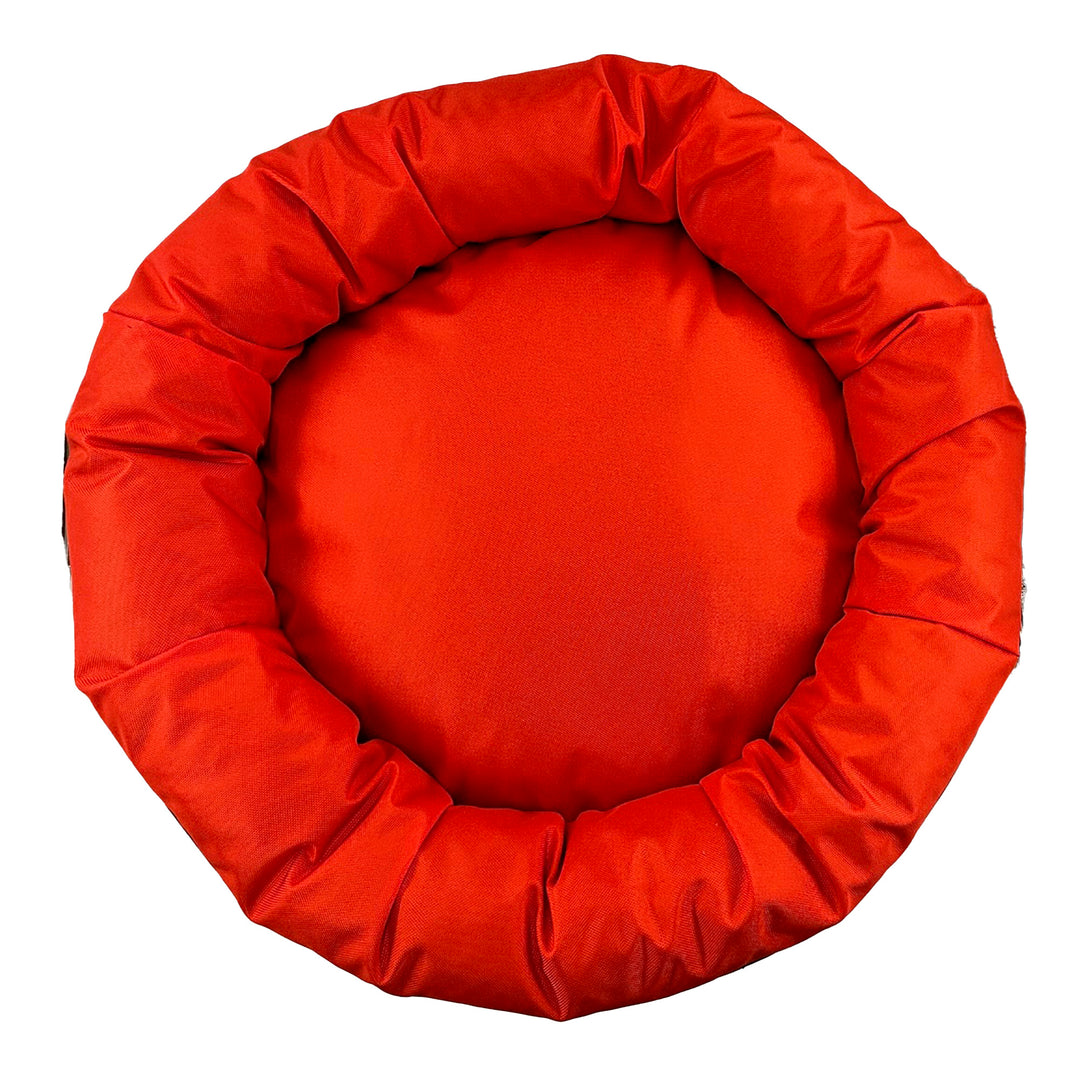Top view of orange round bolstered dog bed.