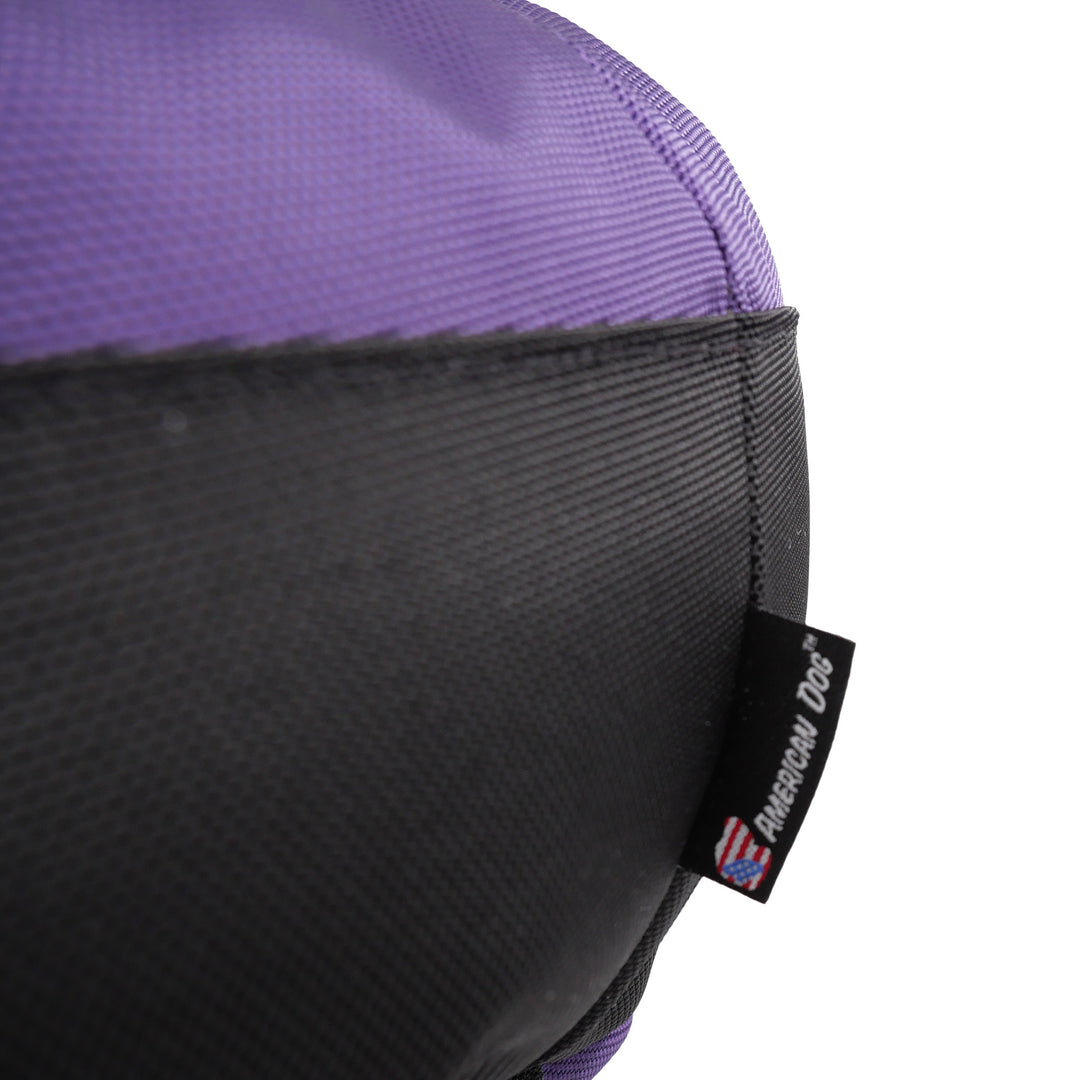 Close up of purple and black fabric and an American Dog label.