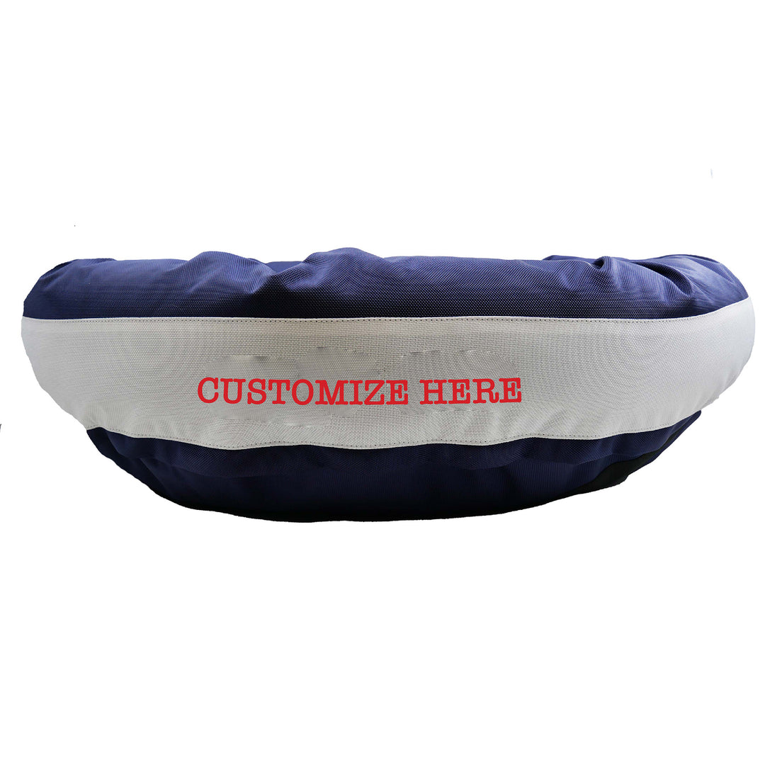 Navy round bolstered dog bed with a silver band and red embroidered 'Customize Here'.