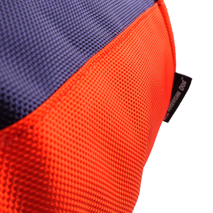 Close up of navy and orange fabric with an American Dog label.