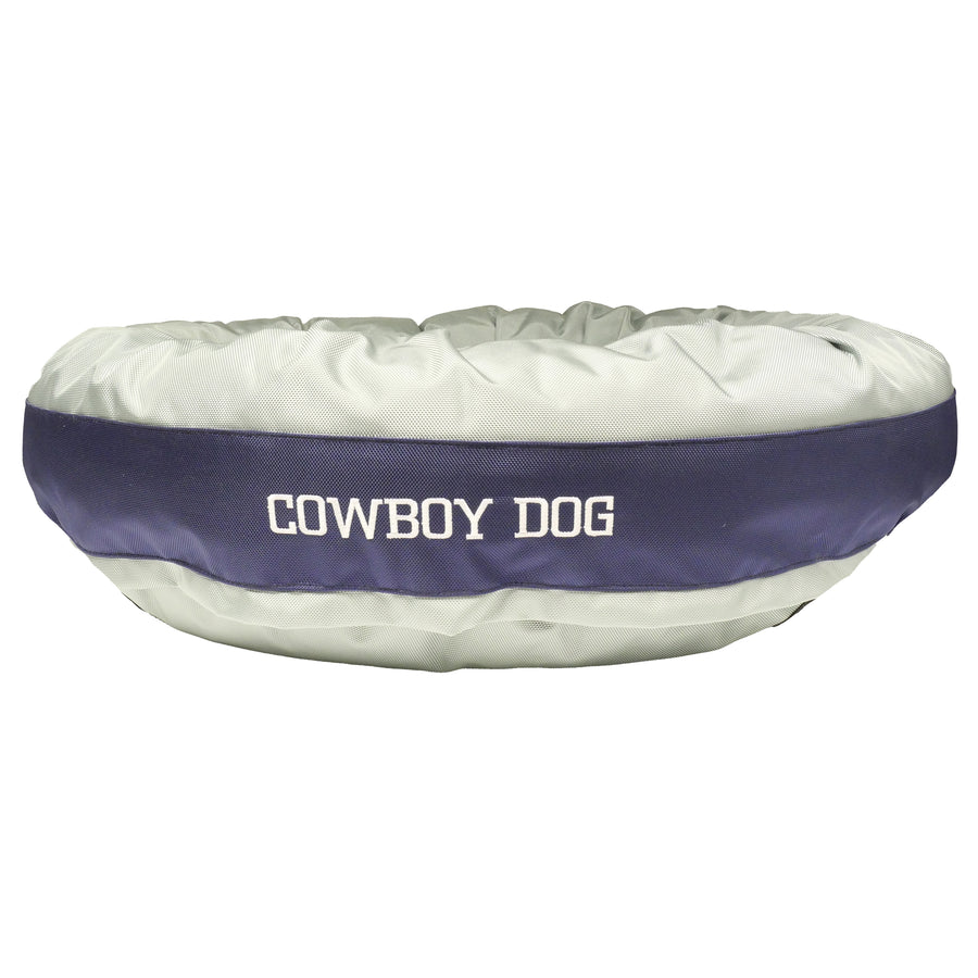 Silver round bolstered dog bed with navy band with white embroidered 'Cowboy Dog.