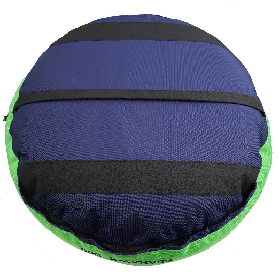 Bottom of navy round bolstered dog bed with black strips and green band.