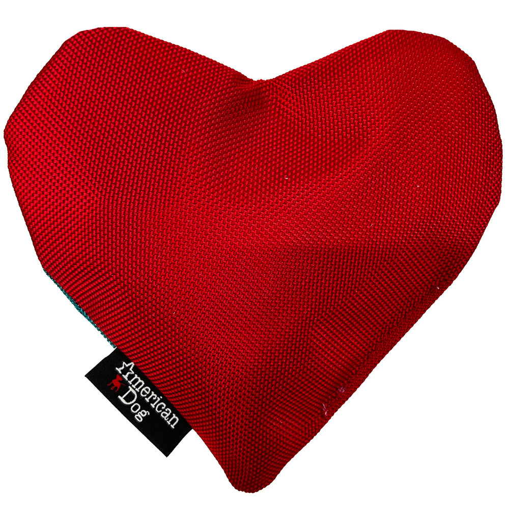 Red heart-shaped dog toy with 'American Dog' tag on a white background