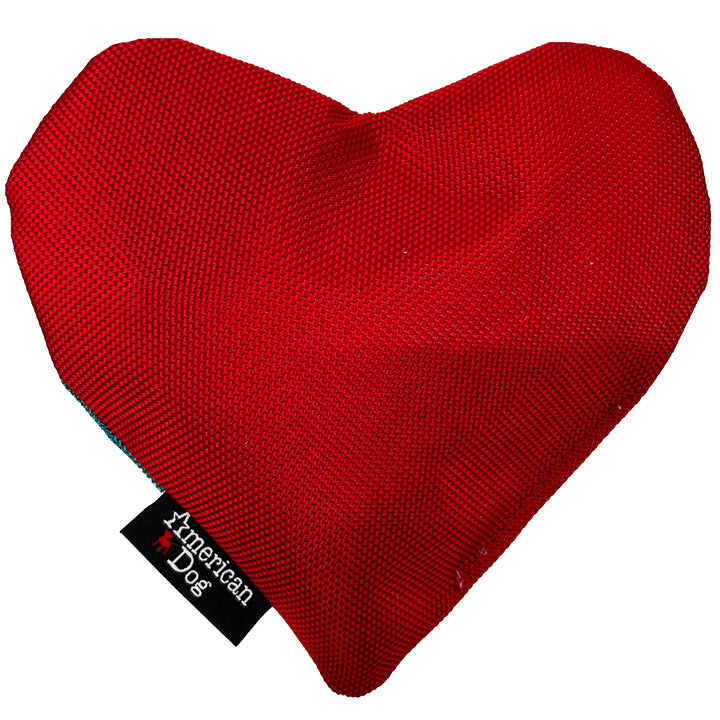 Red heart-shaped dog toy with 'American Dog' tag on a white background