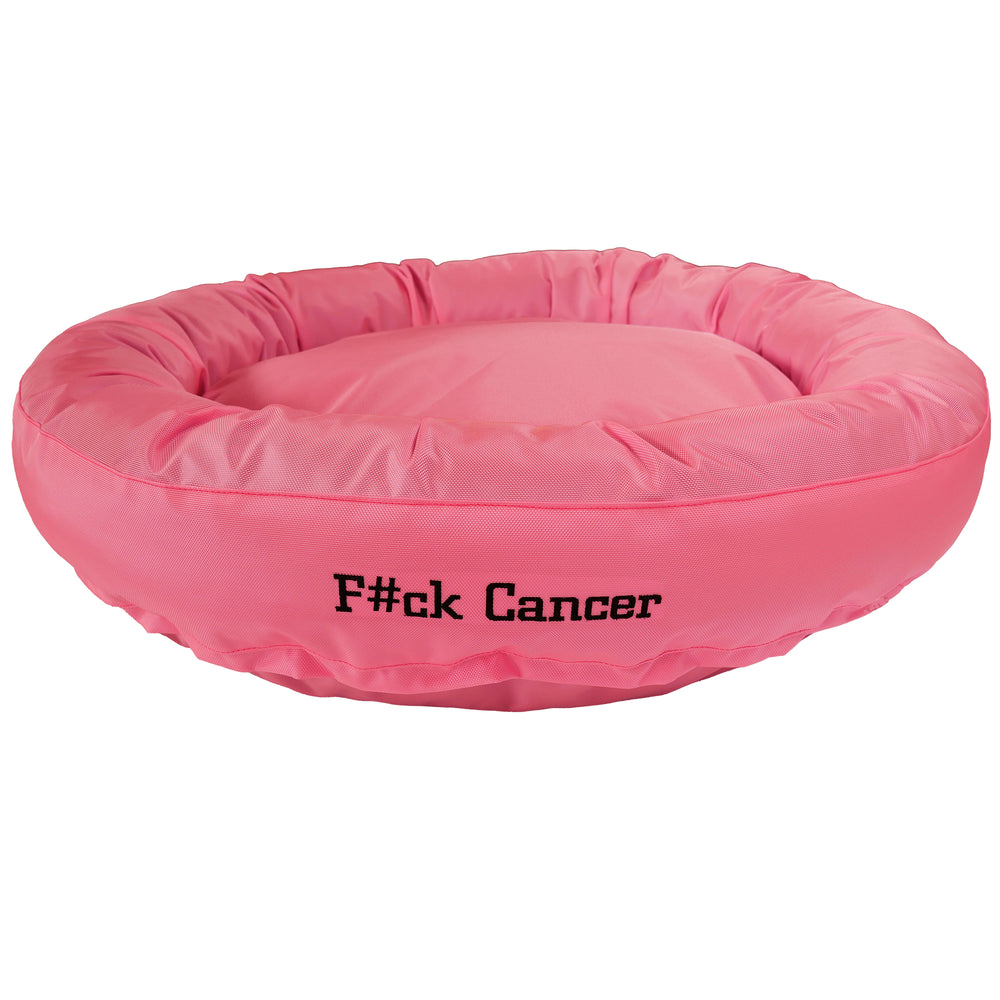 Pink round bolstered dog bed with black embroidered 'F#ck Cancer'.
