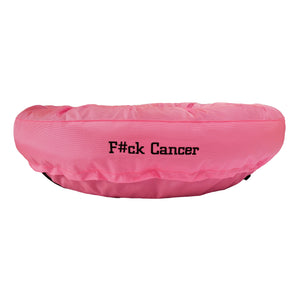 Pink round bolstered dog bed with black embroidered 'F#ck Cancer'.