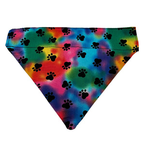 slip on dog bandana with rainbow colors blended together with black dog paw prints 