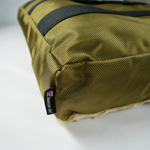close up of texture beige fabric with American Dog label
