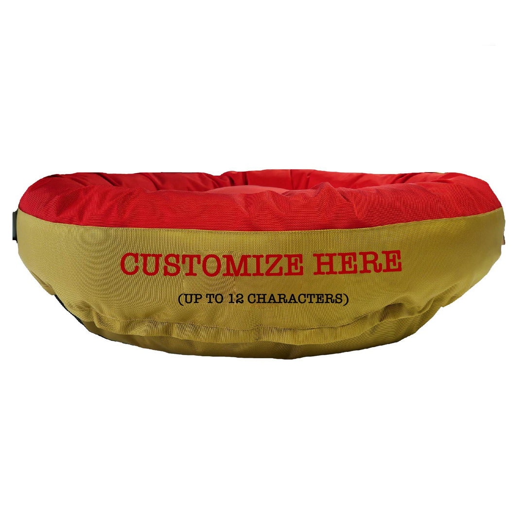 Red and gold round bolstered dog bed with red embroidered 'Customize Here'.