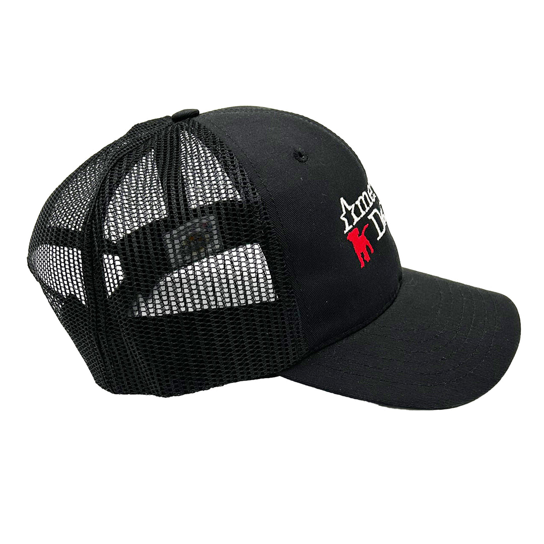 side view of black mesh trucker hat with American Dog logo