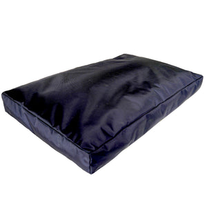 A black rectangular dog bed with a durable outer cover and a plush inner mattress.