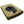 black dog lying on a camel colored fleece dog bed