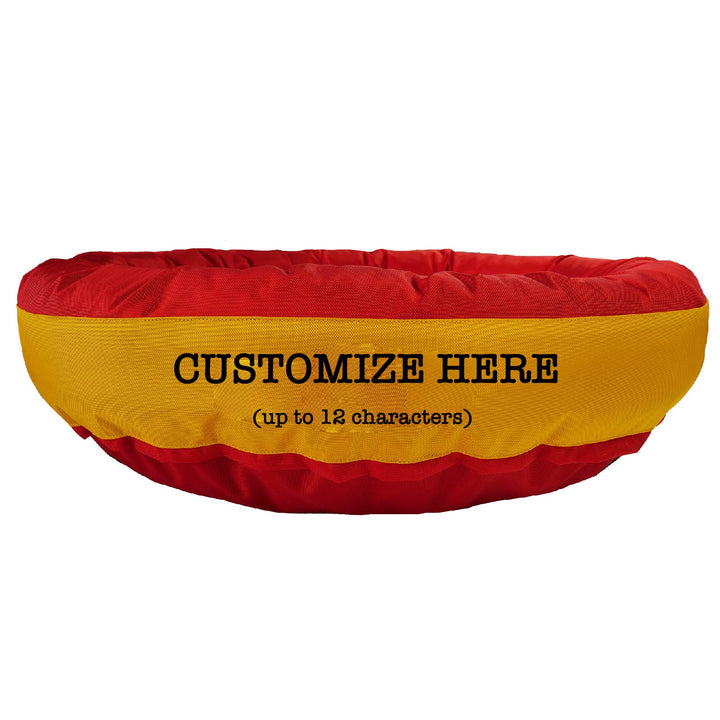 Red round bolstered dog bed with a yellow band and red embroidered 'Customize Here.