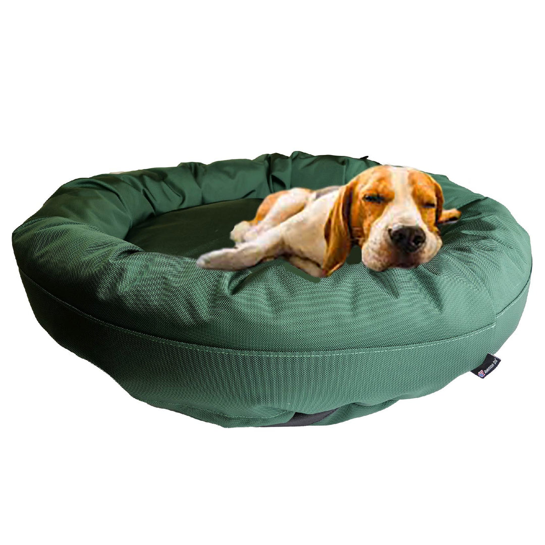 Dark Green round bolstered dog bed with a Beagle laying in it .