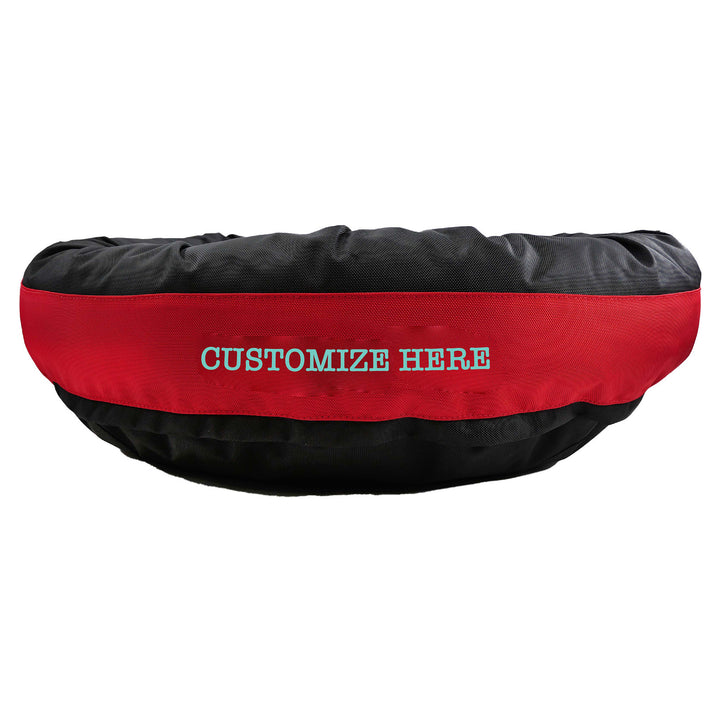 Black round bolstered dog bed with a red band with teal embroidered 'Customize Here'.