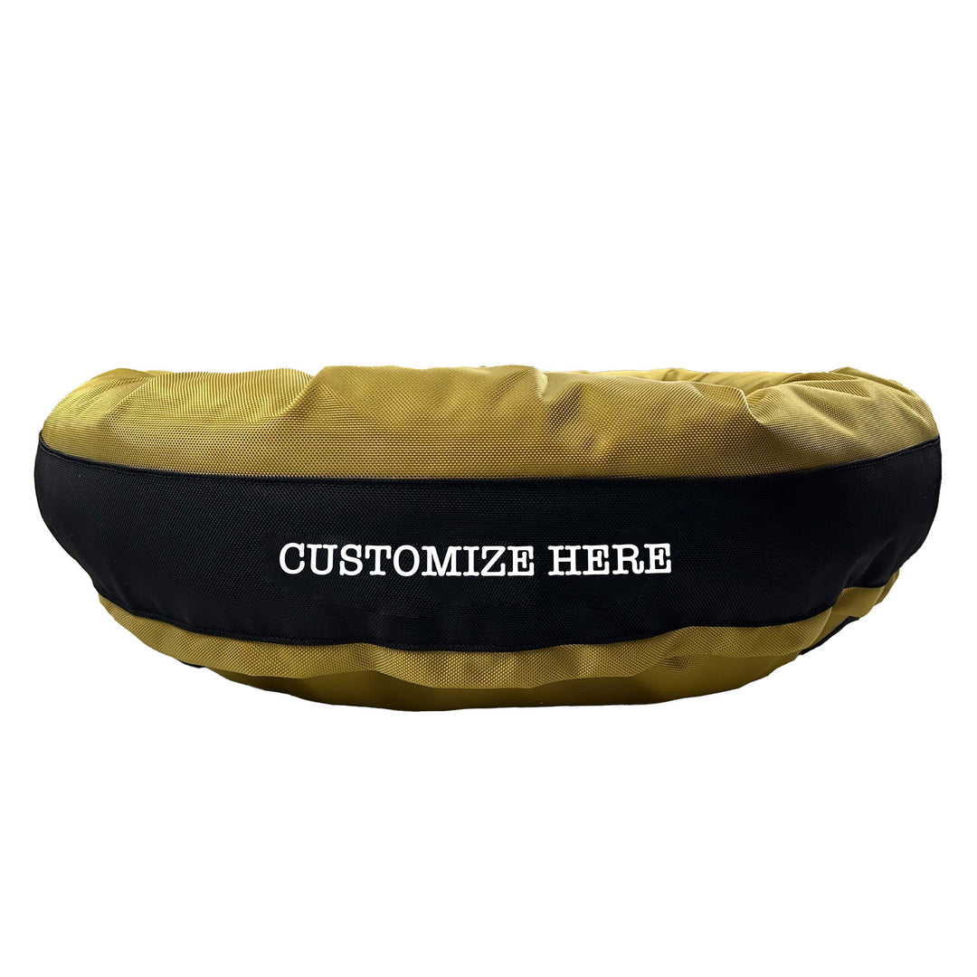  Gold round bolstered dog bed with a black band and white embroidered 'Customize Here'.