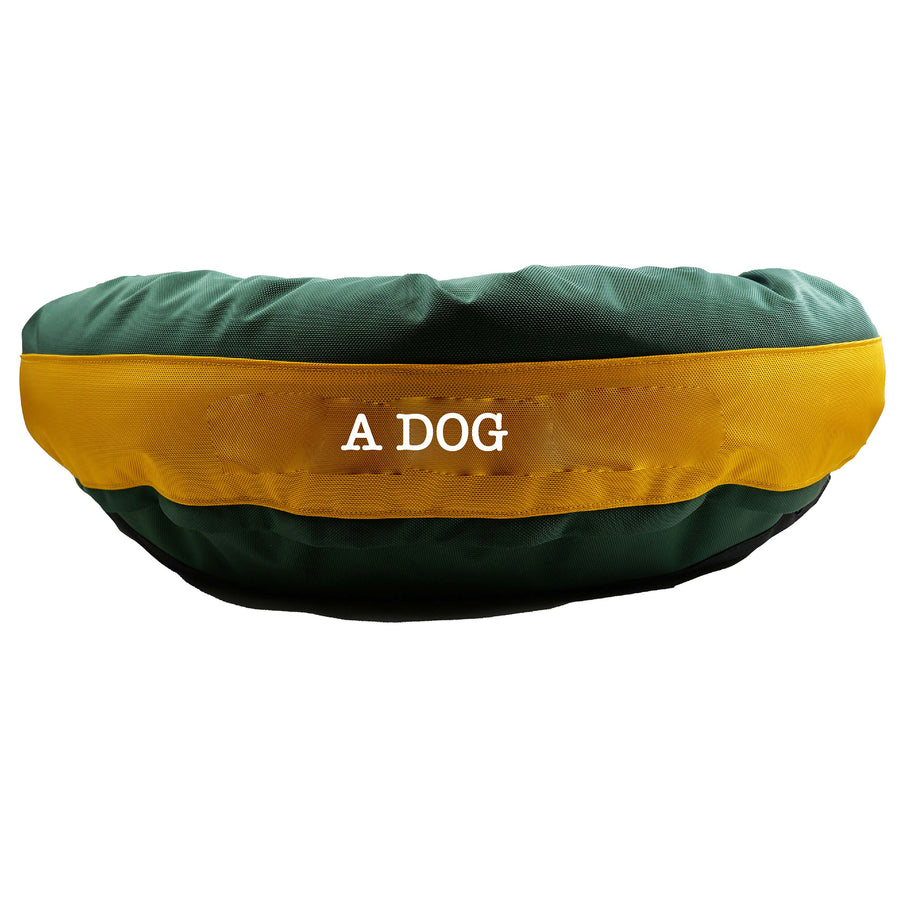 Side view of green dog bed with gold center band. 'A Dog' embroidy