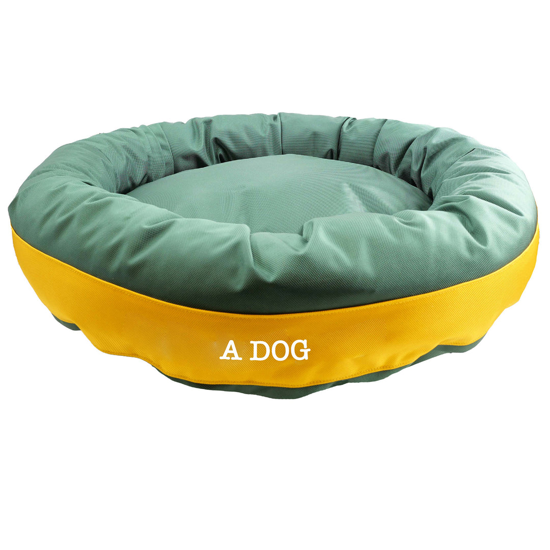 Round bolstered green dog bed with gold center band. 'A Dog' embroidery.