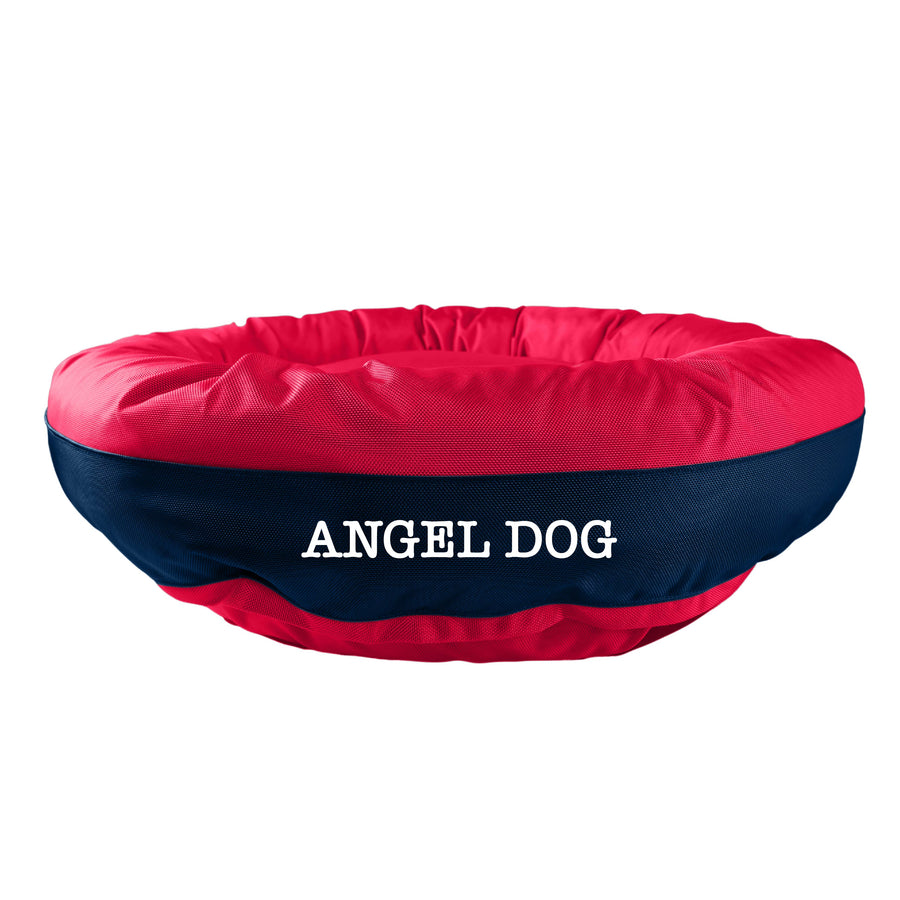 Red dog bed with navy band in the center with 'Angel Dog' embroidered in white.
