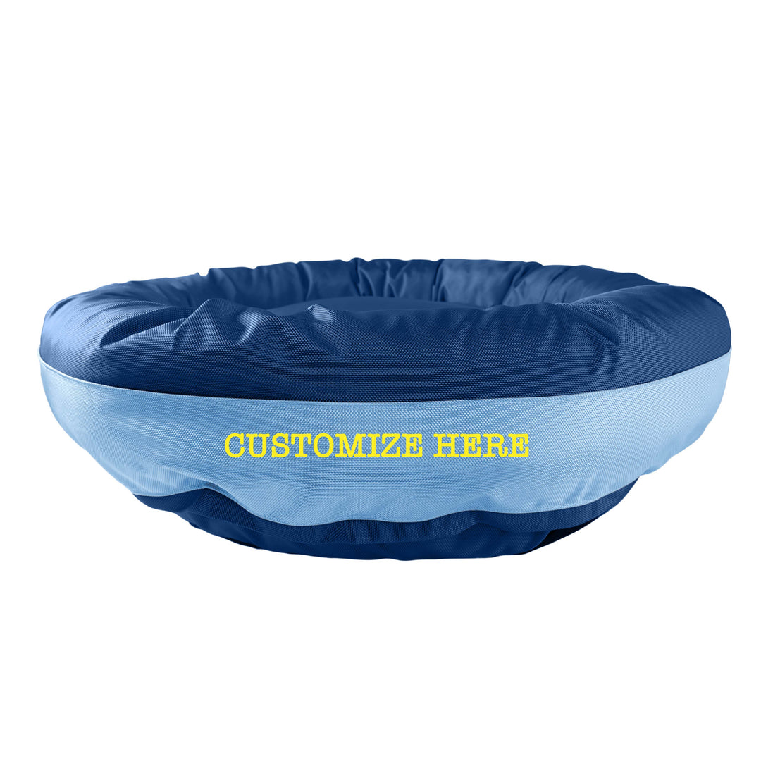 Dark blue round bolstered dog bed with a light blue band and yellow embroidered 'Customize Here'.