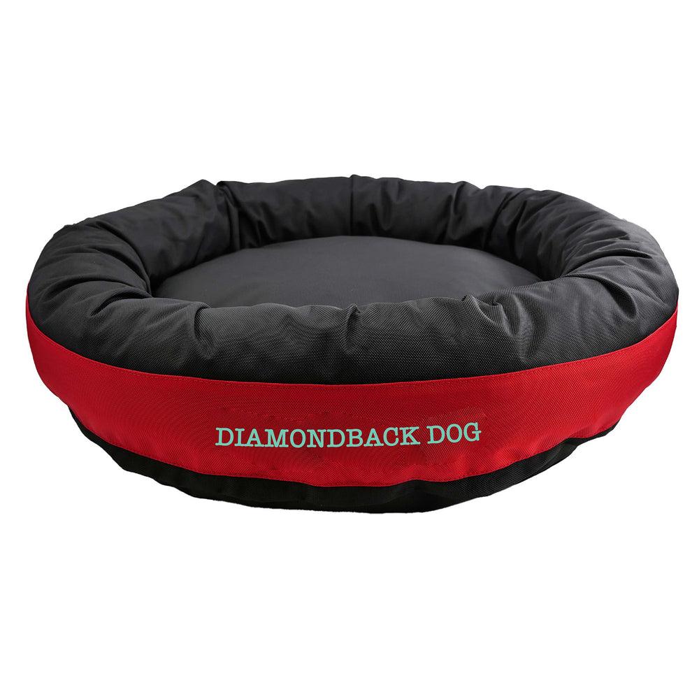 Black round bolstered dog bed with a red band with teal embroidered 'Diamondback Dog'.