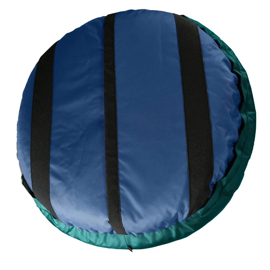 Bottom of navy round bolstered dog bed with black strips and teal band.