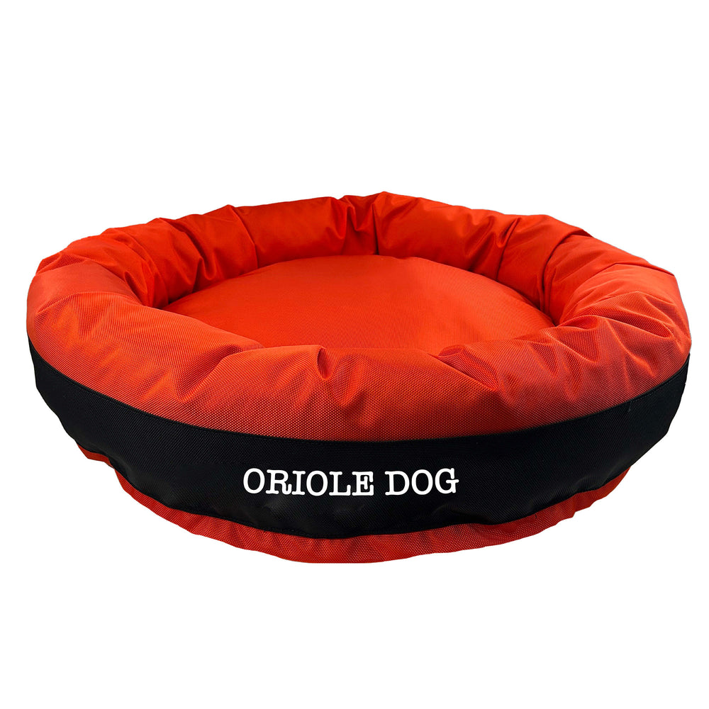 Orange round bolstered dog bed with black band and white embroidered 'Oriole Dog'.