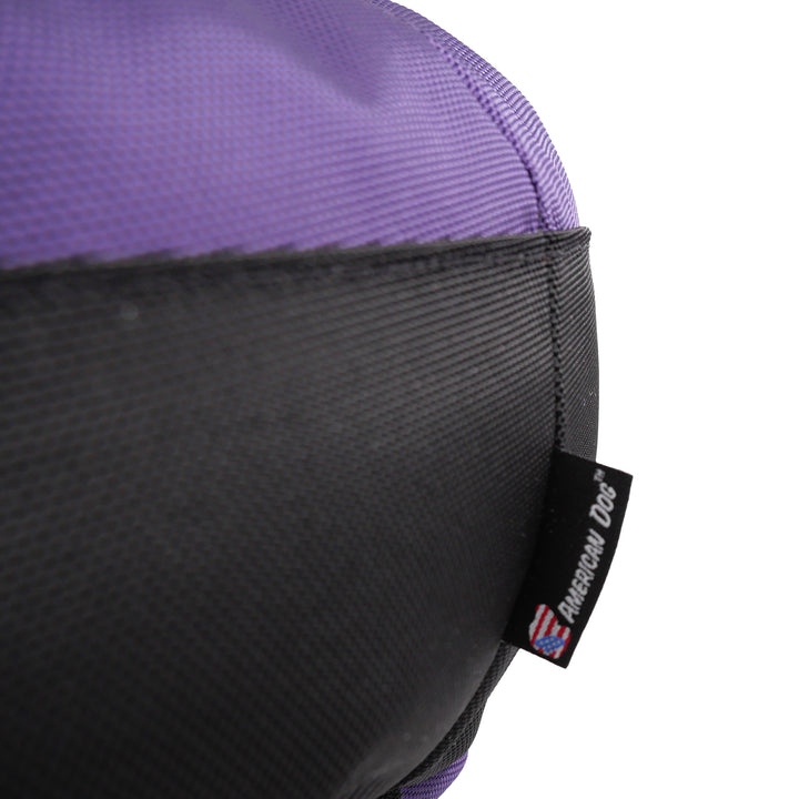 Close up of purple and black fabric and an American Dog label.