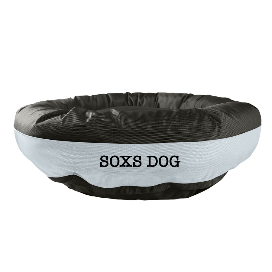 Black round bolstered dog bed with a silver band and black embroidered 'Soxs Dog'.