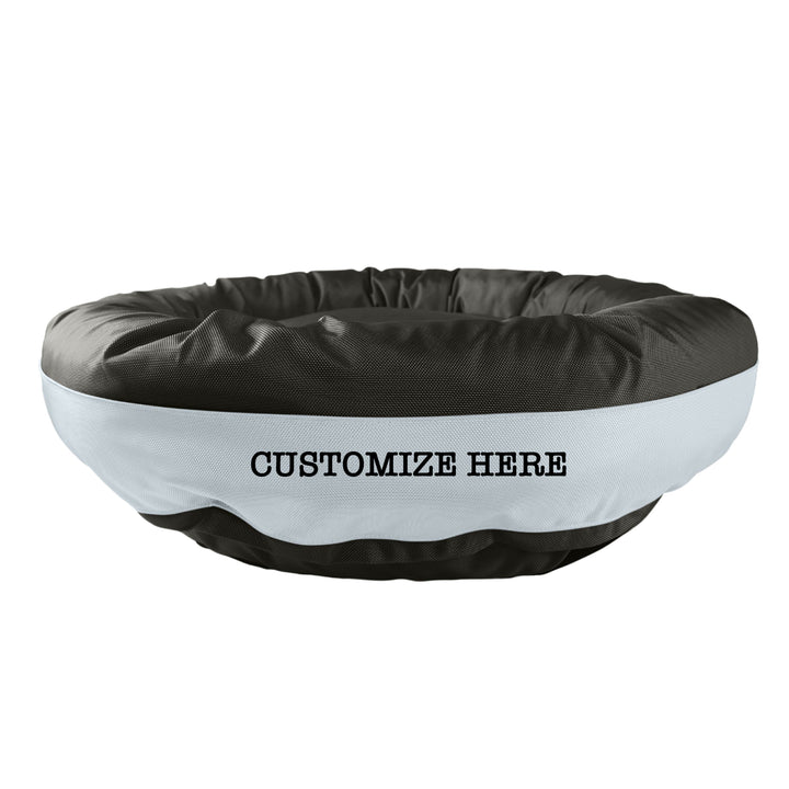 Black round bolstered dog bed with a silver band and black embroidered 'Customize Here'.
