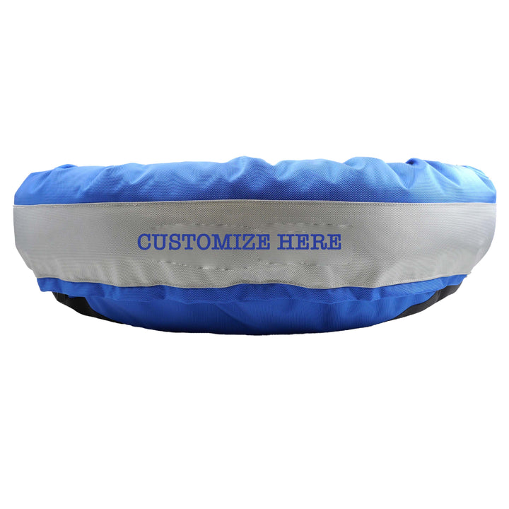 Royal round bolstered dog bed with silver band and royal embroidered 'Customize Here'.