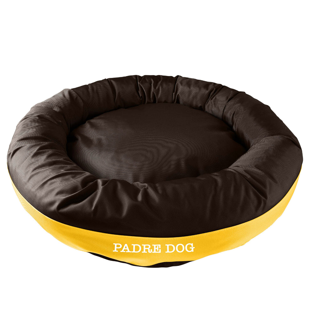 Brown round bolstered dog bed with a yellow band and white embroidered 'Padre Dog'.