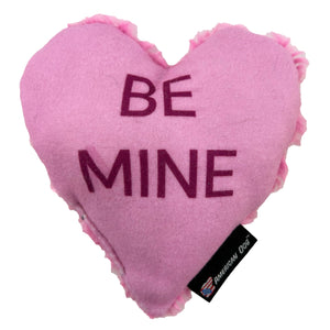 Pink heart shaped dog toy with 'Be Mine' on it