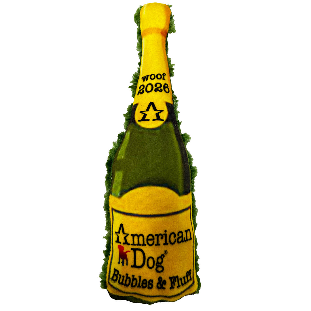 Dog toy shaped like a champagne bottle with 'American Dog' branding on a white background