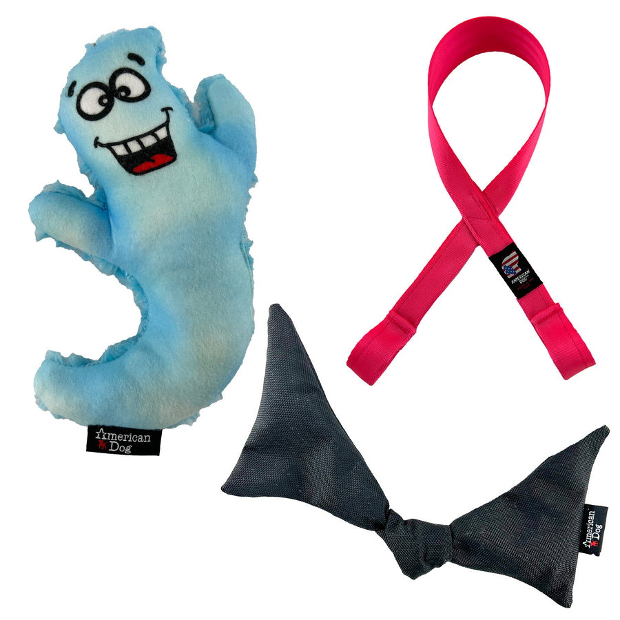 contains a dog toy in the shape of a ghost with a cartoon face, one pink loop with two tug handles in the shape of a ribbon and a black bat shaped dog toy