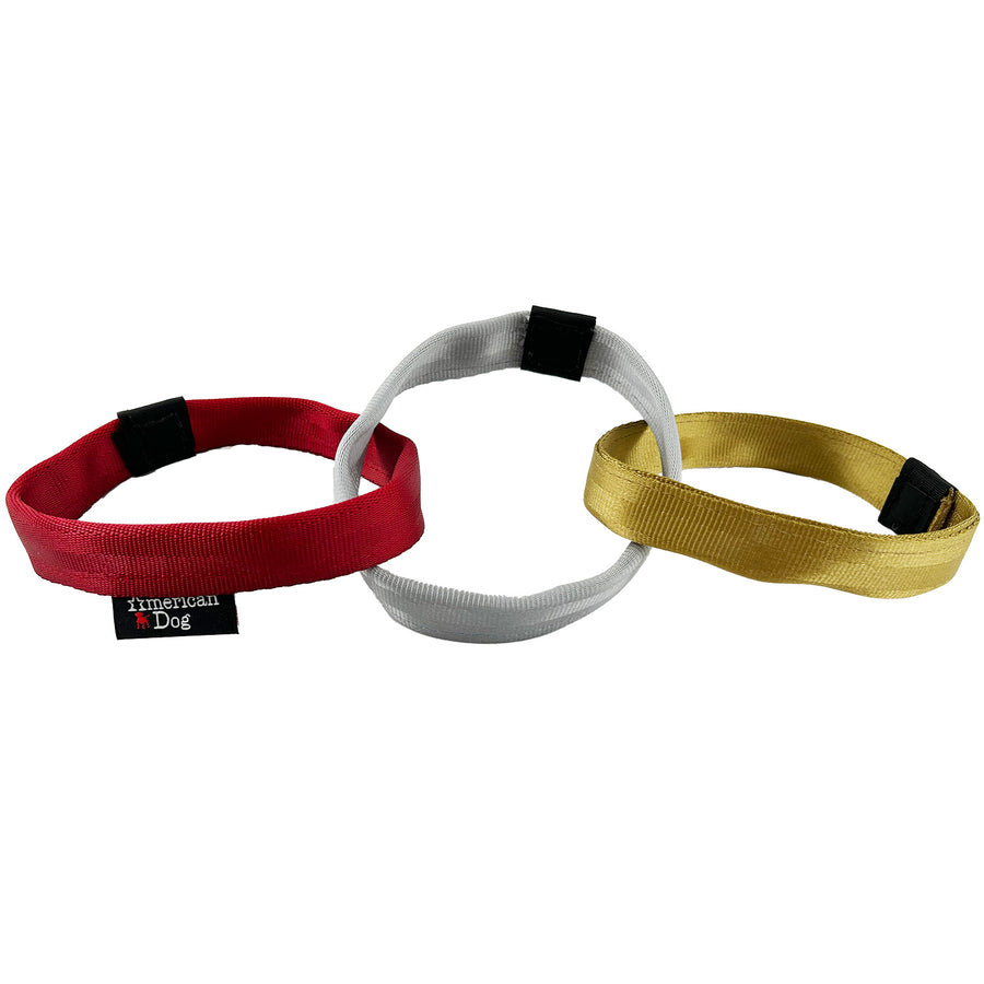 Three connected seat belt web rings of red, silver & gold.