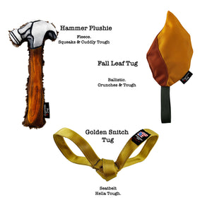 Three plush dog toys arranged on a white background with printed labels: a hammer-shaped plush toy labeled Hammer Plushie, a leaf-shaped plush toy labeled Fall Leaf Tug, and a golden seatbelt-shaped plush toy labeled Golden Snitch Tug.