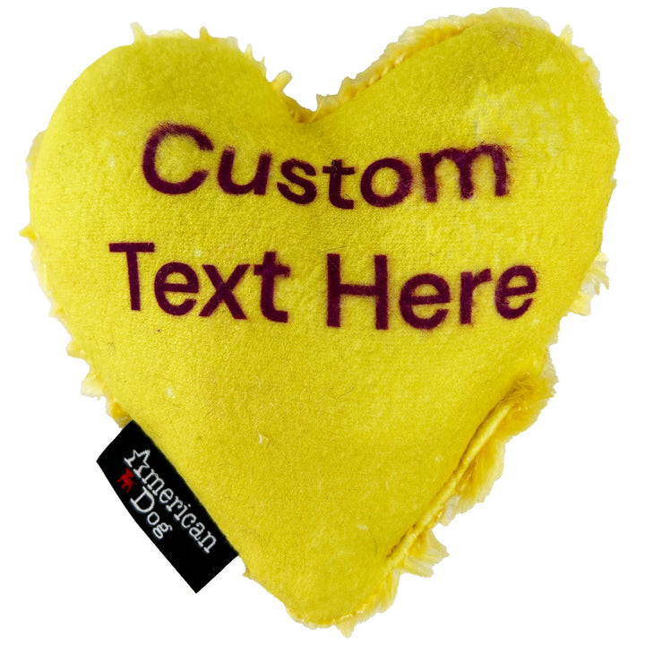 Yellow heart-shaped dog toy with customizable text and American Dog branding.