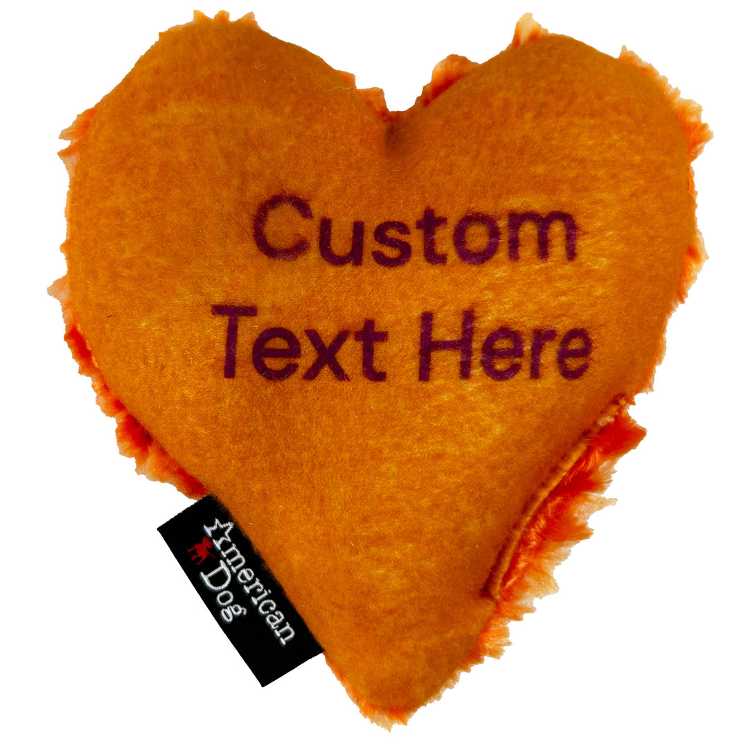 Orange heart-shaped dog toy with customizable text and American Dog branding.