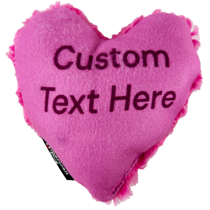 Pink heart-shaped dog toy with customizable text and American Dog branding.