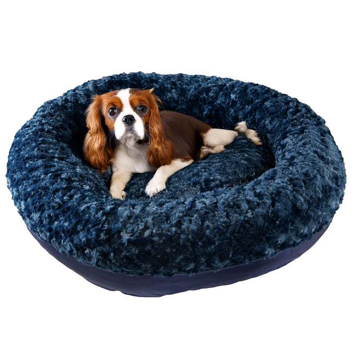 dog lying on a dark blue fleece bolstered dog bed