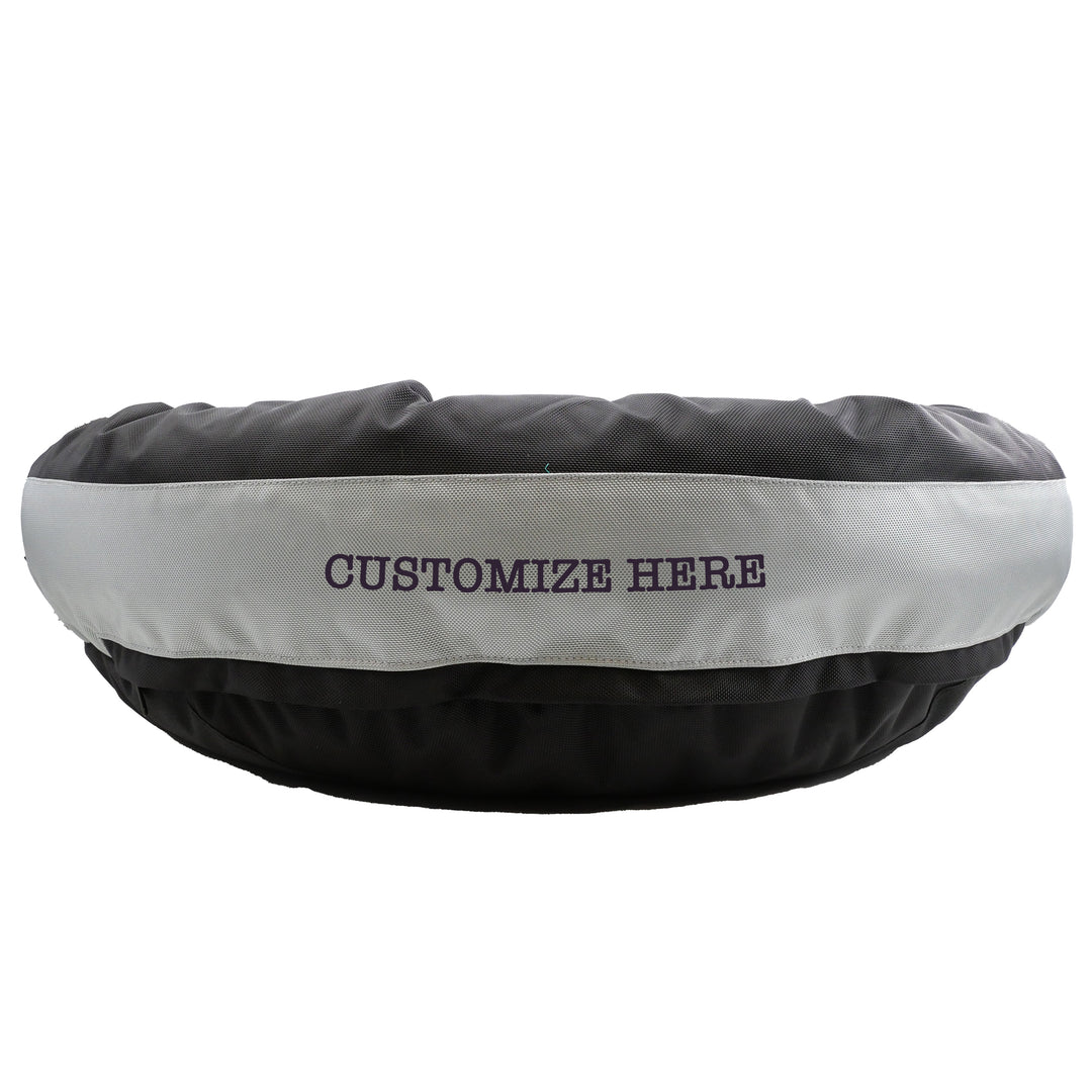 Black round bolstered dog bed with a silver band and black embroidered 'Customize Here'.