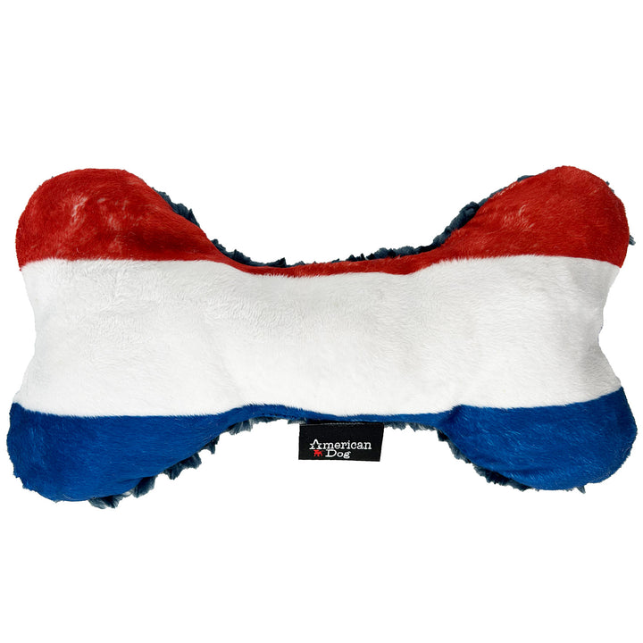 Dog toy shaped like a bone with red, white, and blue fleece colors on a white background. Branded American Dog