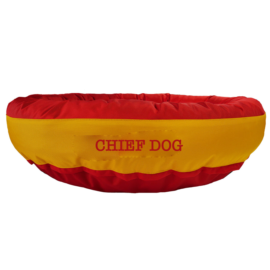 Red round bolstered dog bed with a yellow band and red embroidered 'Chief Dog'.