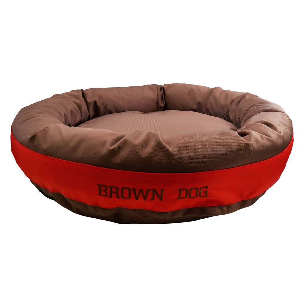 Brown round bolstered dog bed with an orange band and brown embroidered 'Brown Dog'.